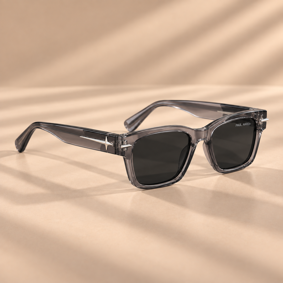 Zikrain The Traitor III sunglasses, transparent grey crystal frame with smoke lenses and silver star studs, angled view